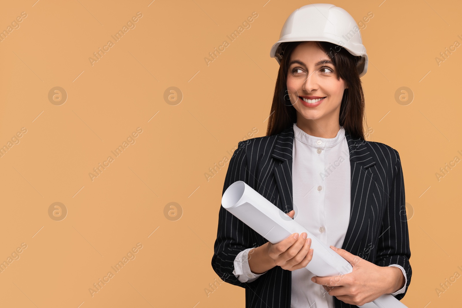 Photo of Architect in hard hat with draft on beige background, space for text