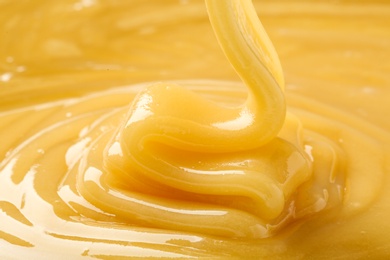 Photo of Pouring fresh sweet honey, closeup