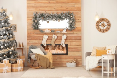 Photo of Beautiful Christmas interior of living room with decorative fireplace