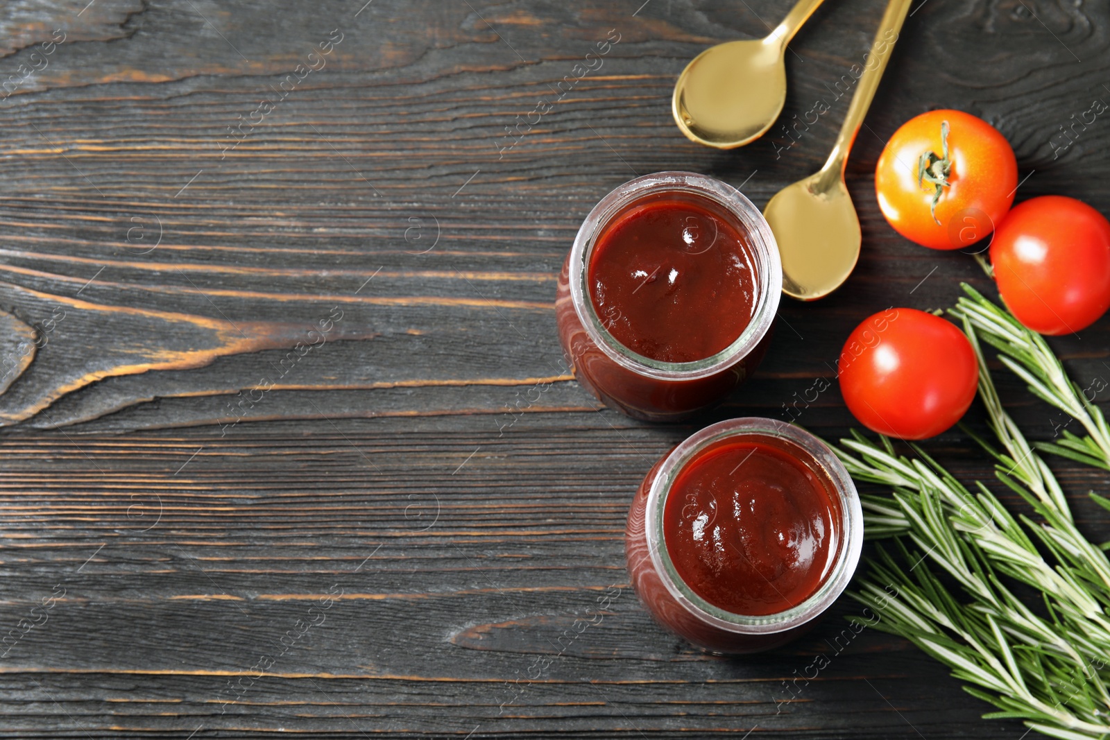 Photo of Flat lay composition with barbecue sauce, rosemary and tomatoes on wooden background. Space for text