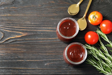 Photo of Flat lay composition with barbecue sauce, rosemary and tomatoes on wooden background. Space for text