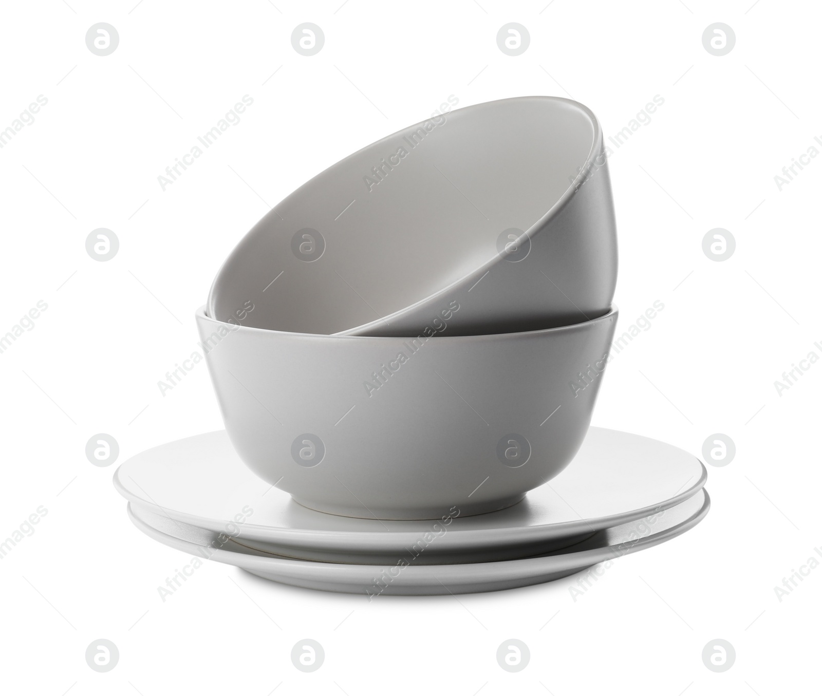 Photo of Stack of clean plates and bowls on white background