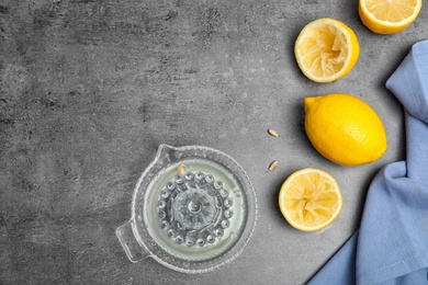 Photo of Flat lay composition with freshly squeezed  lemon juice and space for text on table