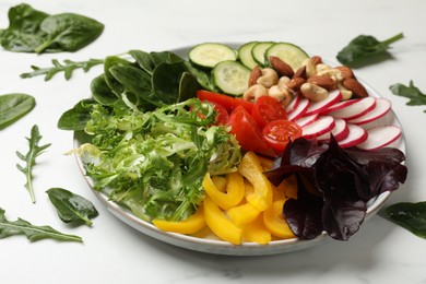 Photo of Balanced diet and vegetarian foods. Plate with different delicious products on white table, closeup