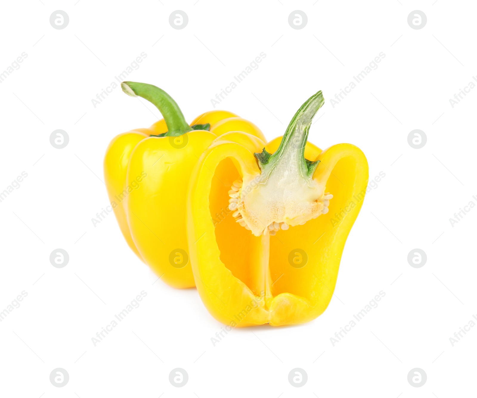 Photo of Whole and cut yellow bell peppers isolated on white