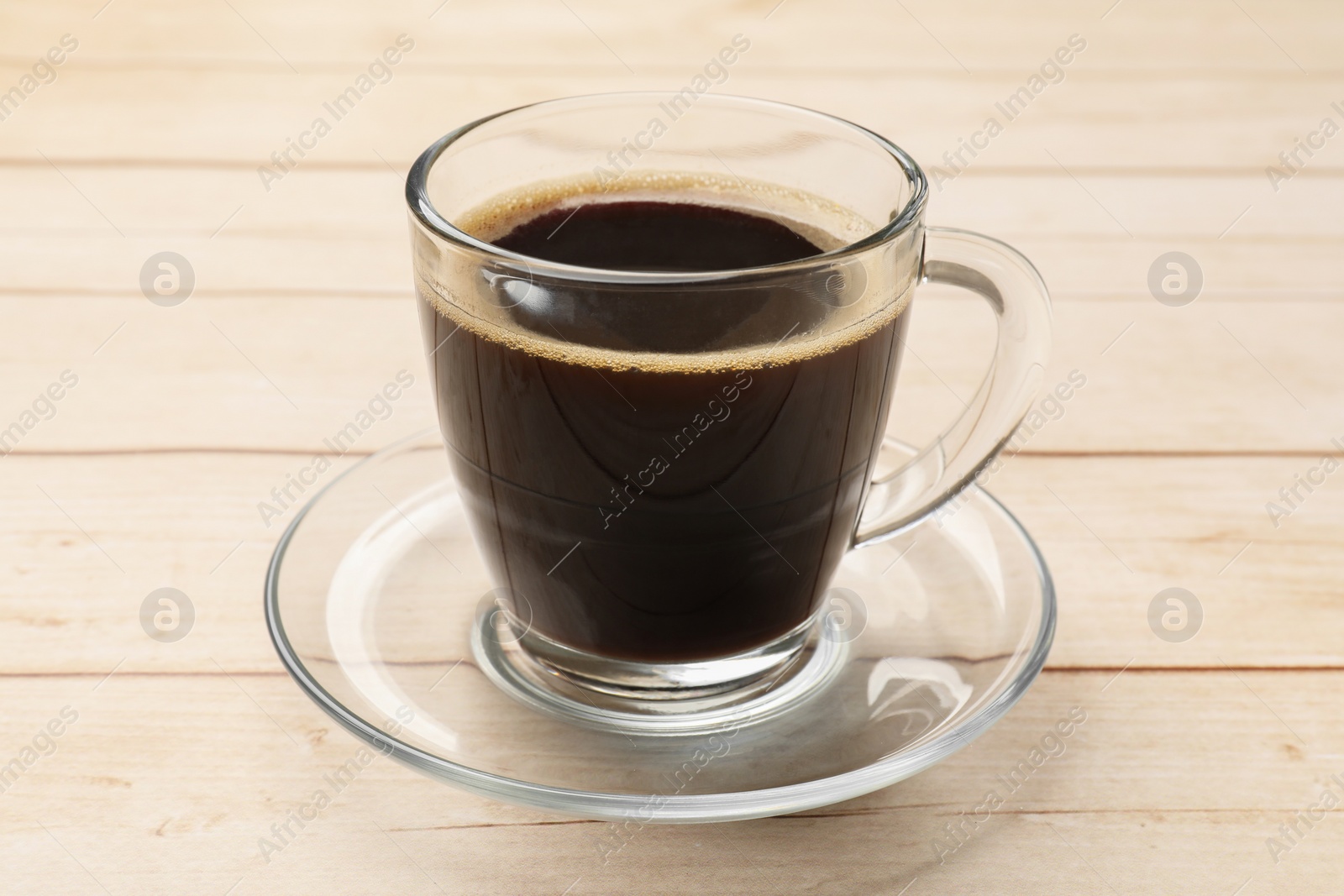 Photo of Cup of aromatic coffee on light wooden table, closeup