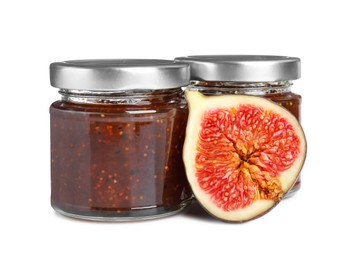 Photo of Glass jars of tasty sweet fig jam isolated on white