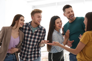 Photo of Group of happy people talking in light room