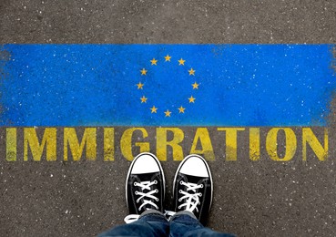 Image of Immigration. Woman standing on asphalt near flag of European Union, top view