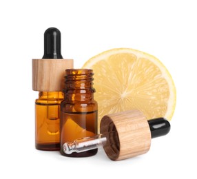 Bottles of citrus essential oil and fresh lemon isolated on white