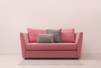 Photo of Simple room interior with comfortable pink sofa, space for text