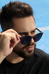 Photo of Handsome man in sunglasses outdoors on sunny day