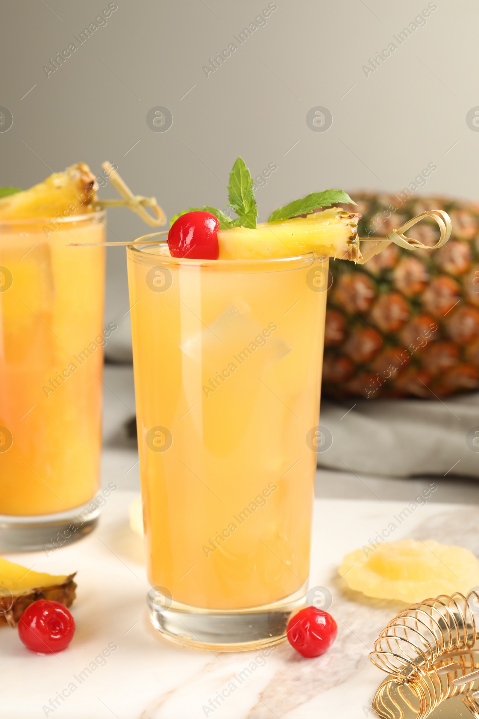 Photo of Tasty pineapple cocktail with mint and cherry on table