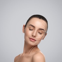 Attractive woman with perfect skin after cosmetic treatment on grey background. Lifting arrows on her face