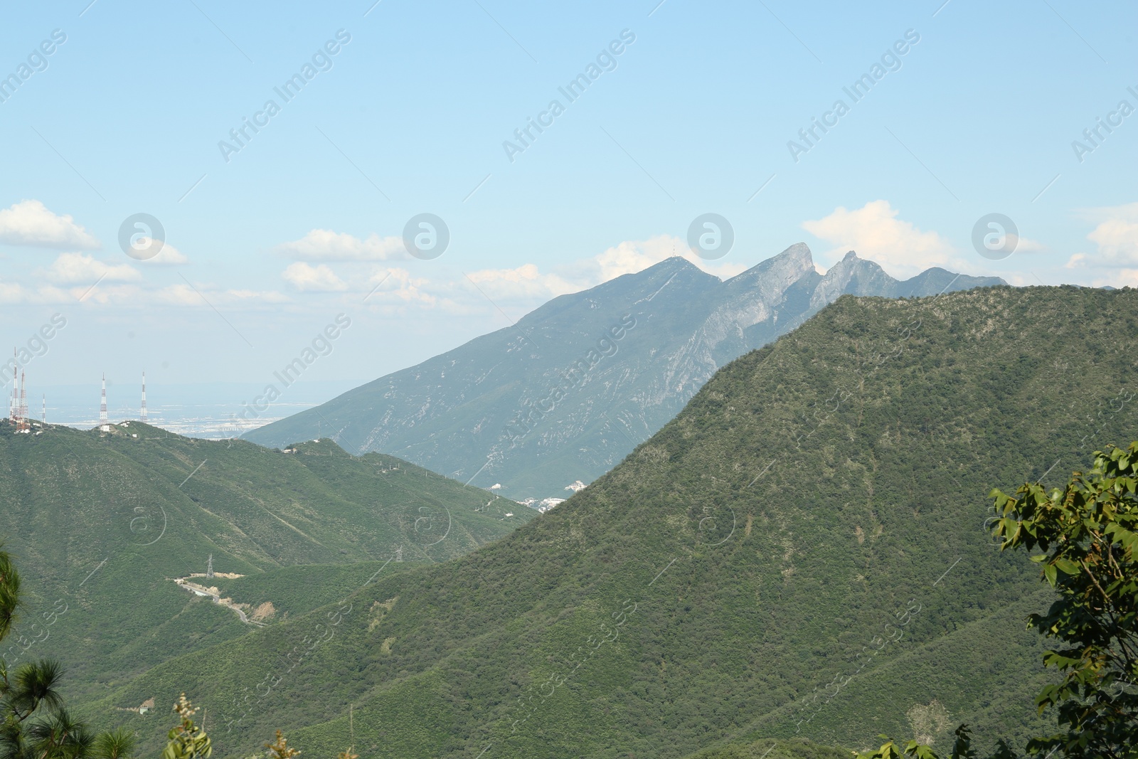 Photo of Picturesque view of mountains and trees under cloudy sky