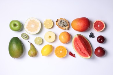 Photo of Different ripe fruits and berries on white background, top view