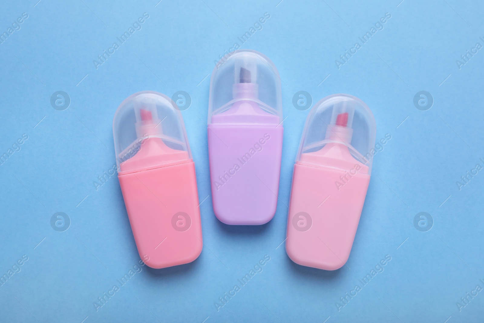 Photo of Colorful markers on light blue background, flat lay