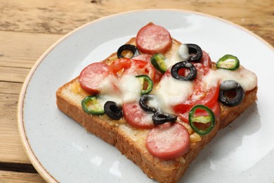 Tasty pizza toast on wooden table, closeup