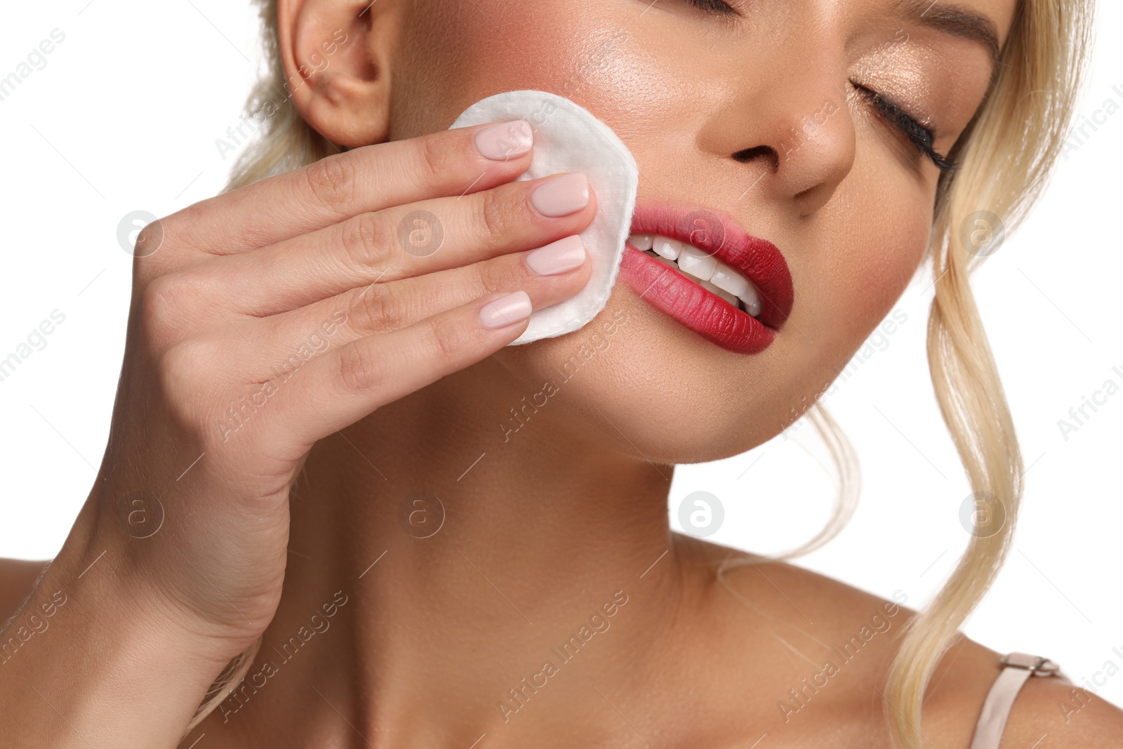 Photo of Beautiful woman removing makeup with cotton pad on white background, closeup