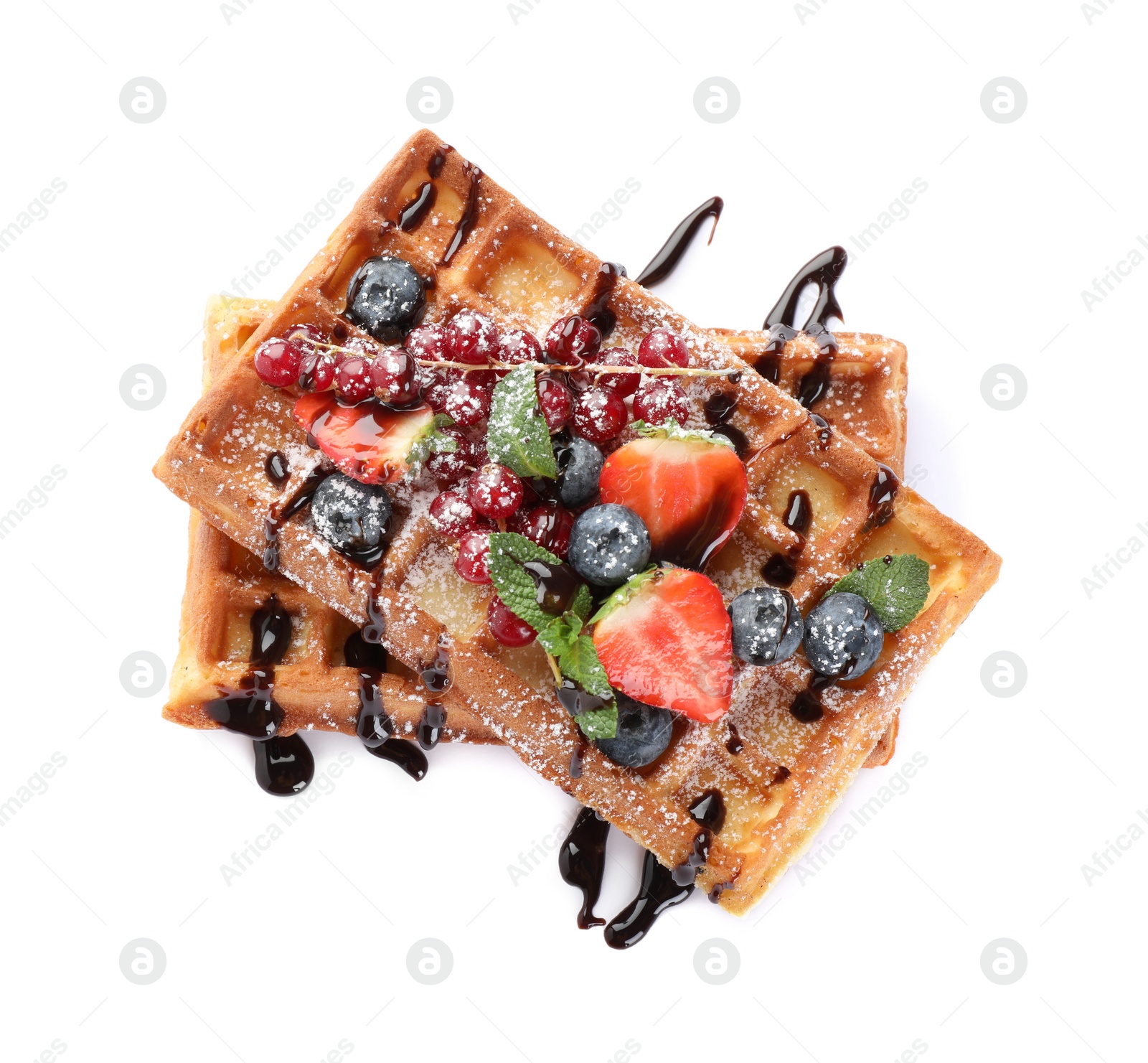 Photo of Delicious Belgian waffles with berries on white background, top view