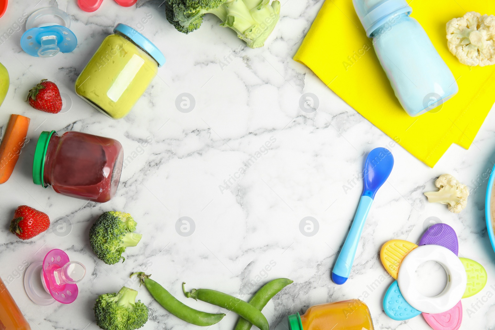 Photo of Frame of healthy baby food, ingredients and accessories on white marble table, flat lay. Space for text