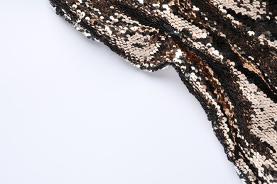 Photo of Golden shiny sequin fabric on white background. Space for text