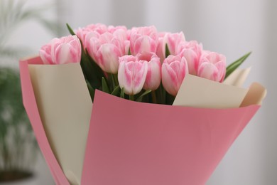 Beautiful bouquet of fresh pink tulips on blurred background, closeup