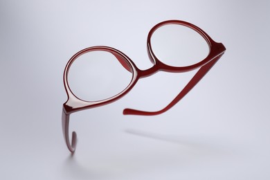 Stylish pair of glasses on light grey background
