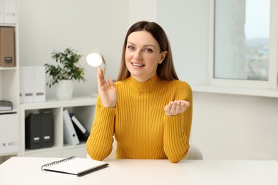 Photo of Woman having video chat at table in office, view from web camera