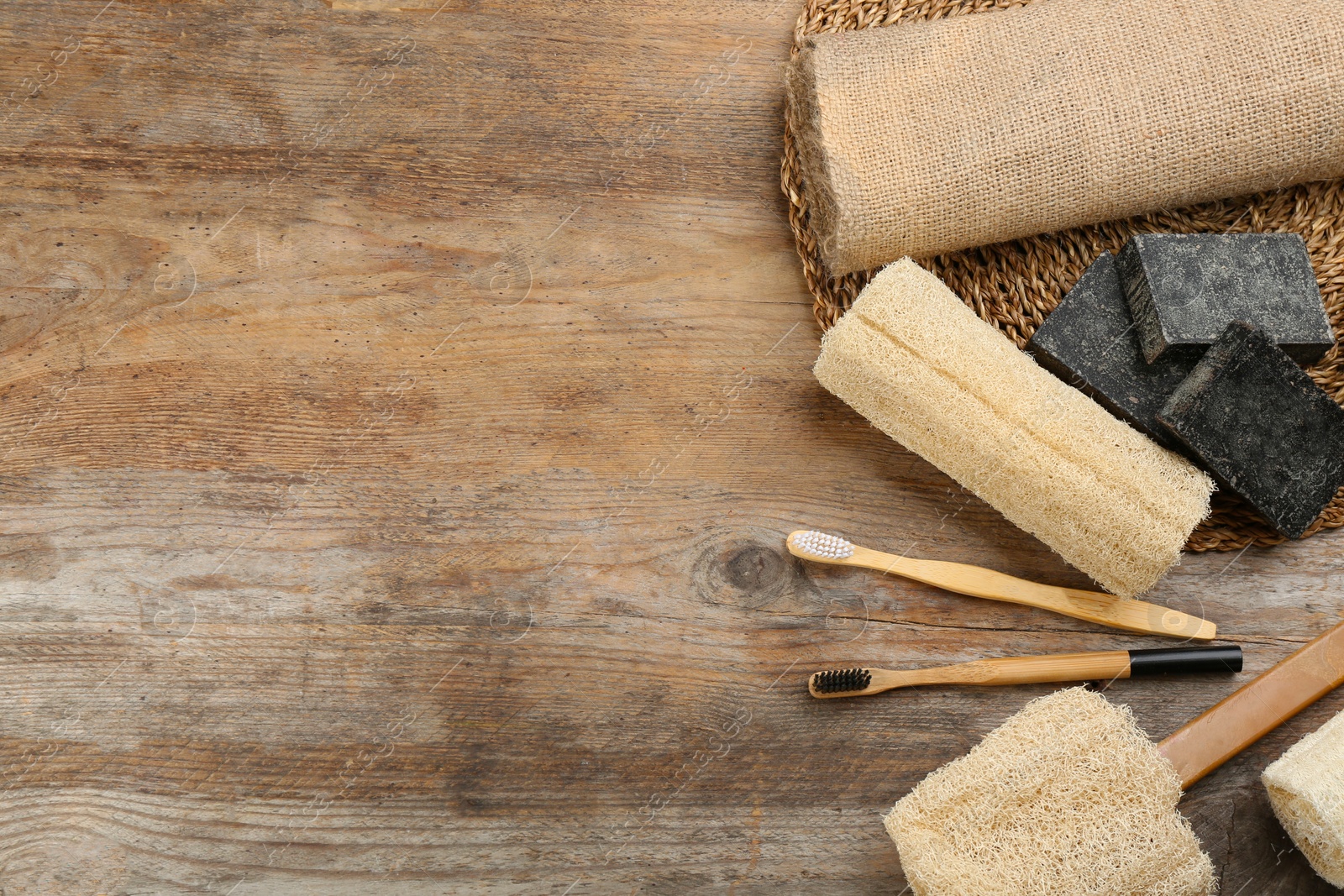 Photo of Flat lay composition with bamboo toothbrushes on wooden table. Space for text