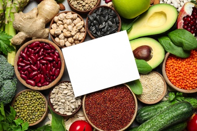 Flat lay composition with different vegetables, seeds and fruits on grey table, space for text. Healthy diet