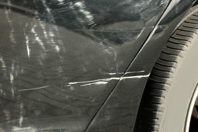 Modern black car with scratch, closeup view