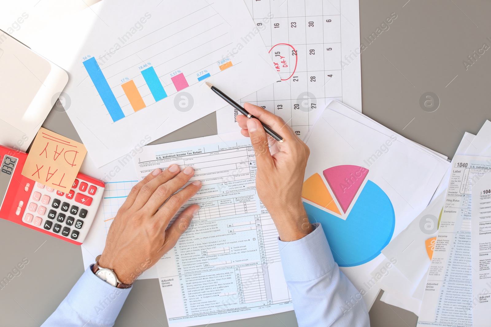 Photo of Tax accountant working with documents at table