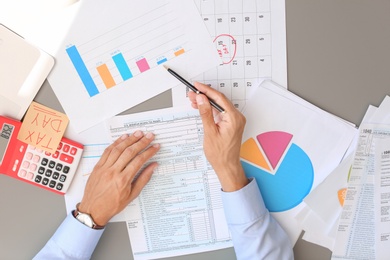 Tax accountant working with documents at table