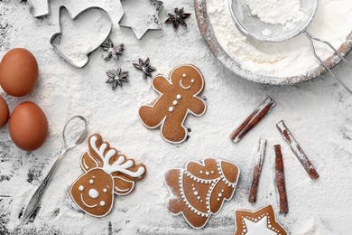 Flat lay composition with delicious homemade Christmas cookies and flour on table