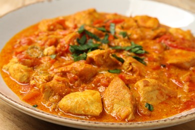 Photo of Delicious chicken curry with parsley in plate, closeup