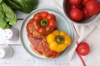 Photo of Delicious stuffed bell peppers on white wooden table, flat lay