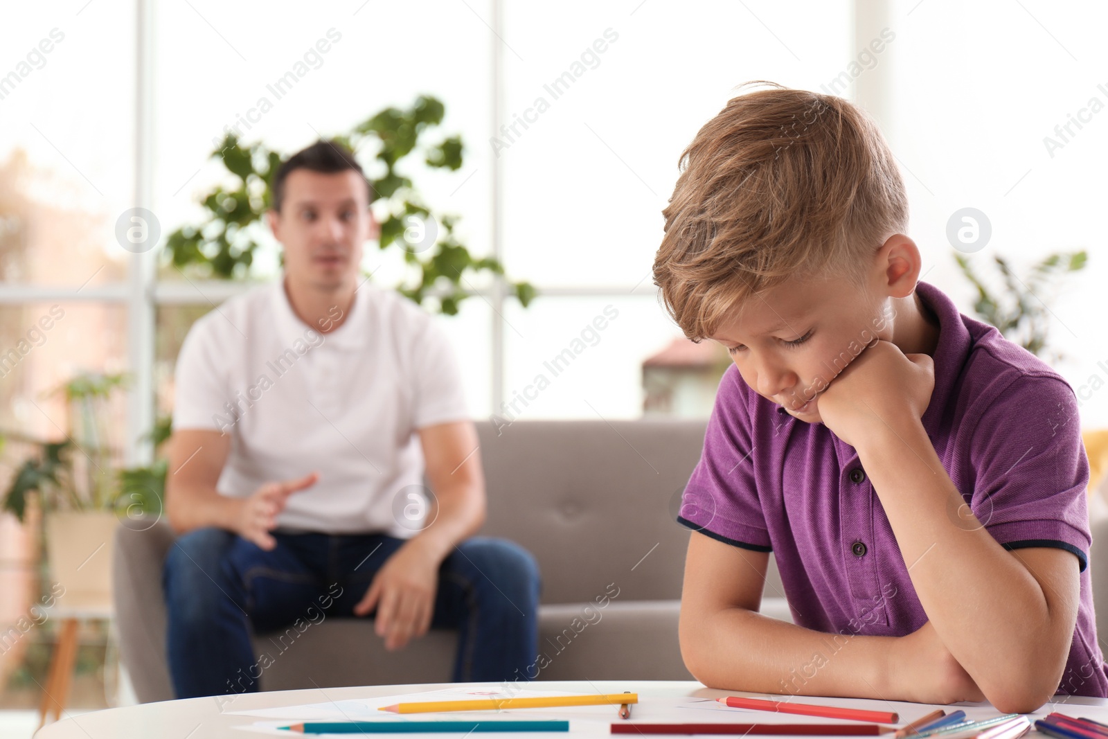 Photo of Father scolding child at home. Family relationships