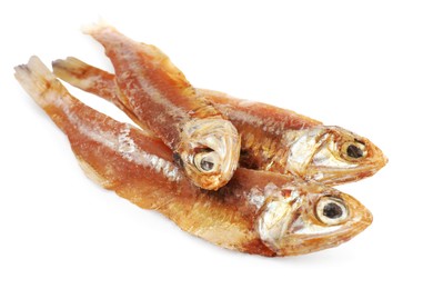 Photo of Delicious dried salted anchovies on white background