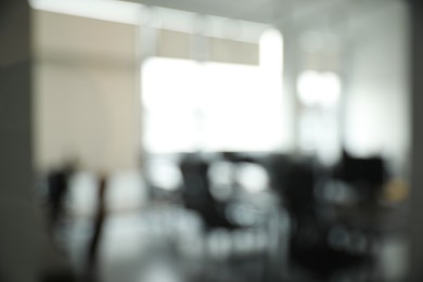 Photo of Blurred view of cozy workspaces with tables and chairs in office