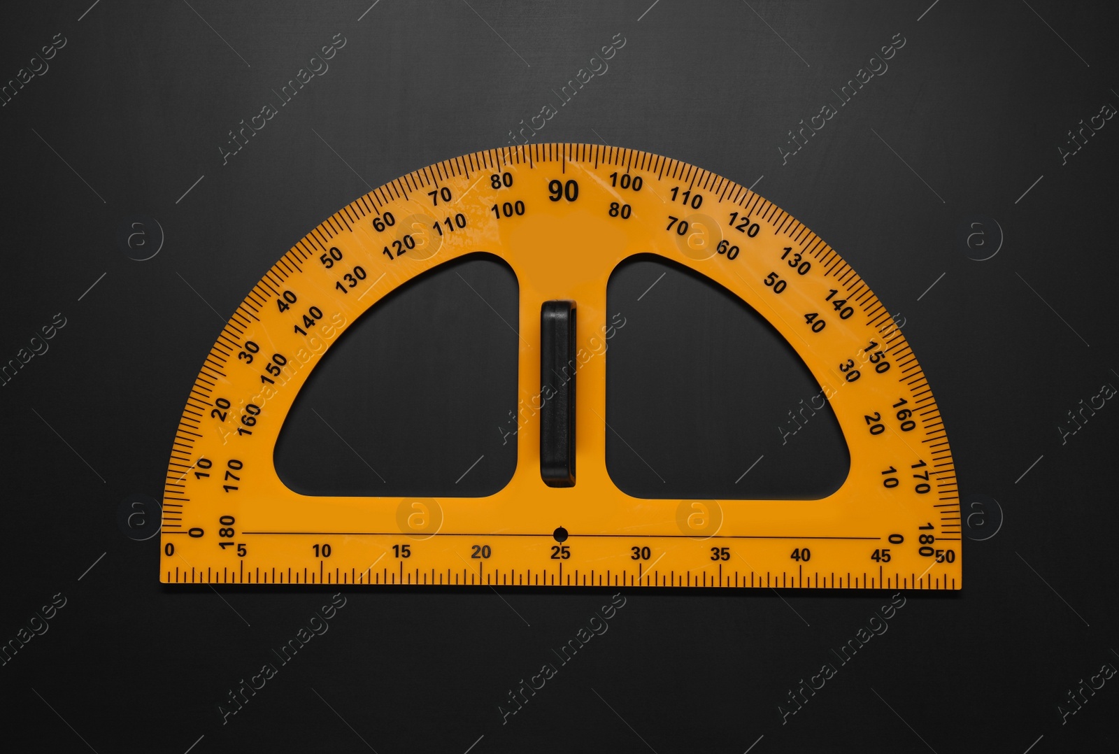 Photo of Yellow school protractor on blackboard, top view