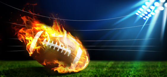Image of Leather American ball with flame on green football field. Banner design  