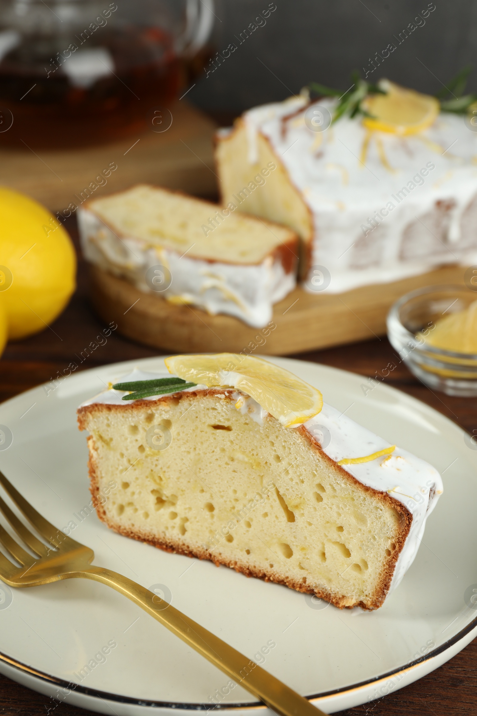 Photo of Piece of tasty lemon cake with glaze served on table, closeup