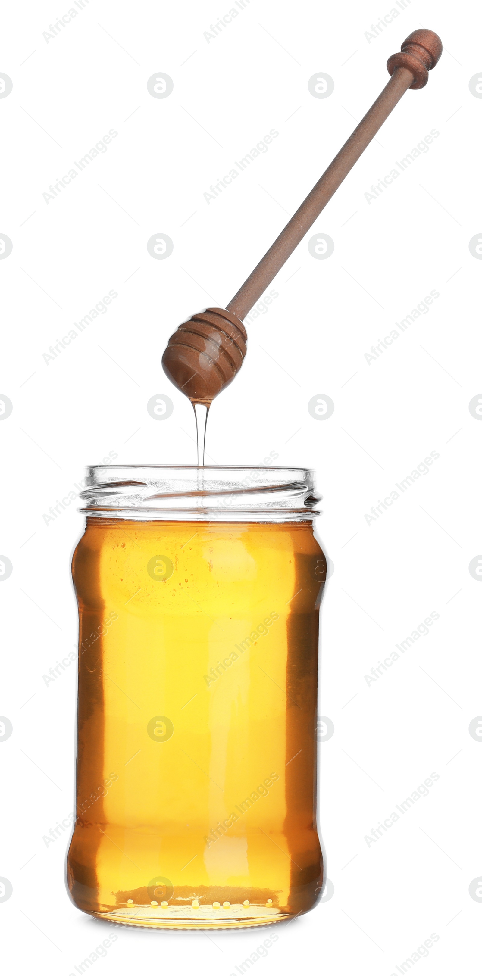 Photo of Honey dripping from wooden dipper into jar isolated on white
