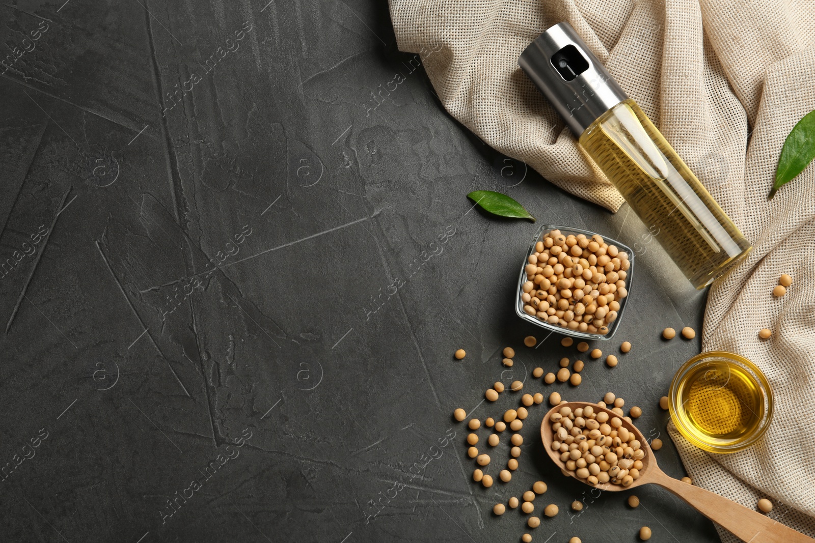 Photo of Flat lay composition with soybean oil on grey table. Space for text