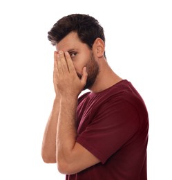 Photo of Embarrassed man covering face with hands on white background