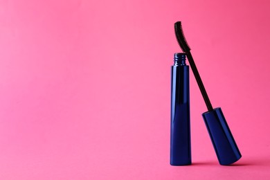 Photo of Mascara on bright pink background, space for text