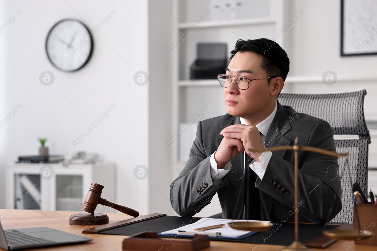 Photo of Notary working at wooden table in office, space for text