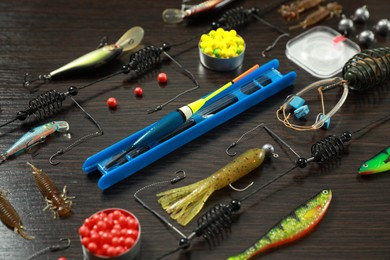 Photo of Fishing tackle on dark wooden background, closeup