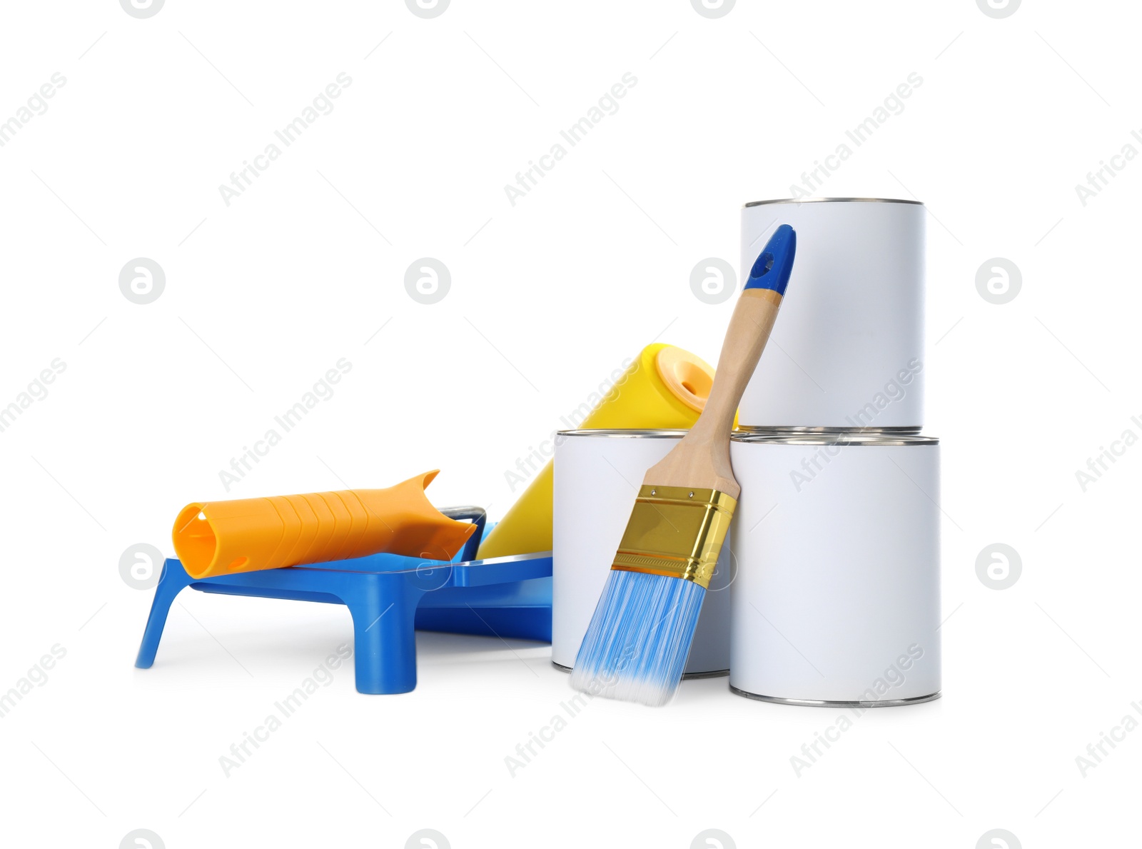 Photo of Closed blank cans of paint with brush, roller and tray isolated on white